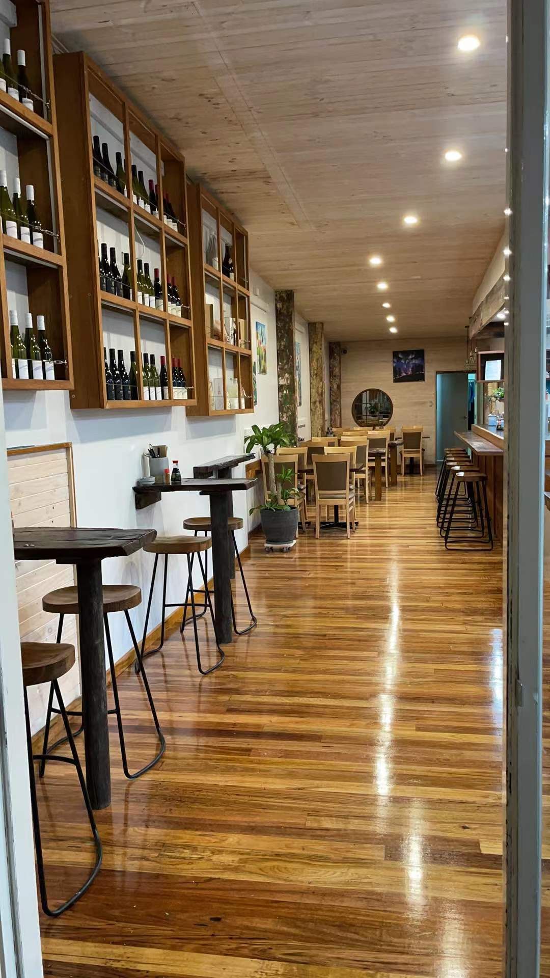 Blue Fin restaurant interior with polished timber floors, wine shelves and bistro seating